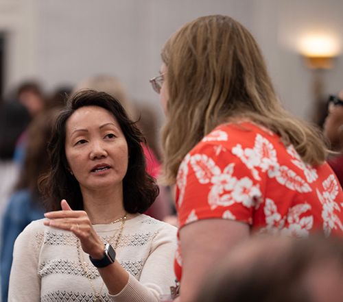 Summit Attendees Discussing a Topic
